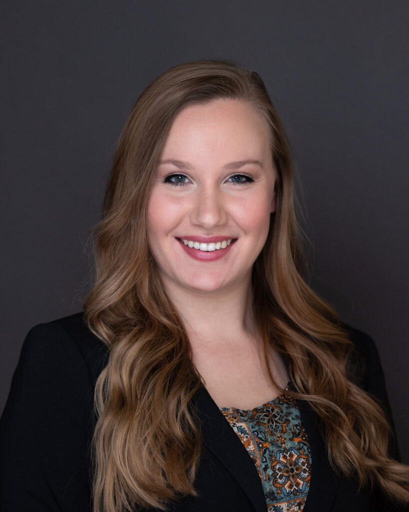 Professional headshot of Carmen Ladika, Certified QuickBooks ProAdvisor at MBE CPAs, smiling against a dark background.