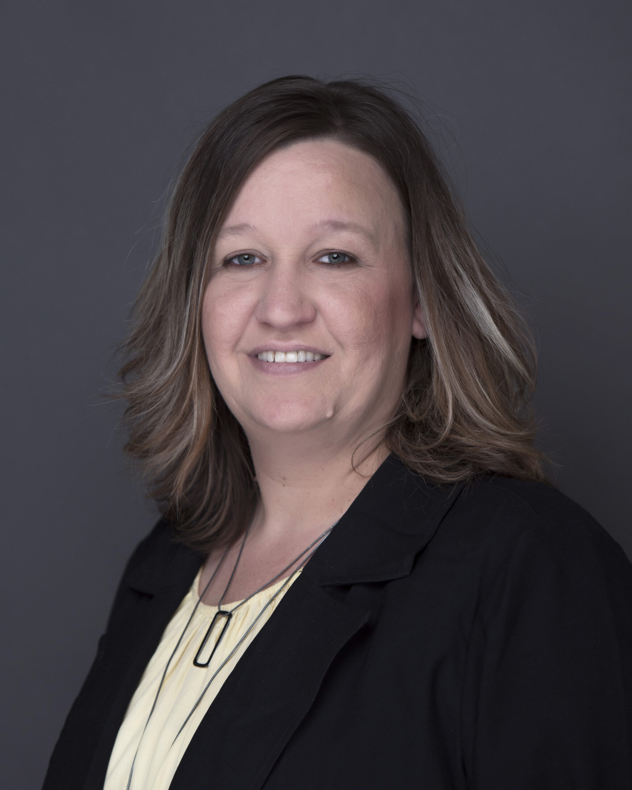Professional headshot of Heather Schilling, Certified QuickBooks ProAdvisor at MBE CPAs, smiling against a dark background.