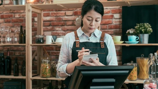 Cashier Staff Taking Note