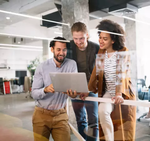 People Smiling While Looking on Laptop