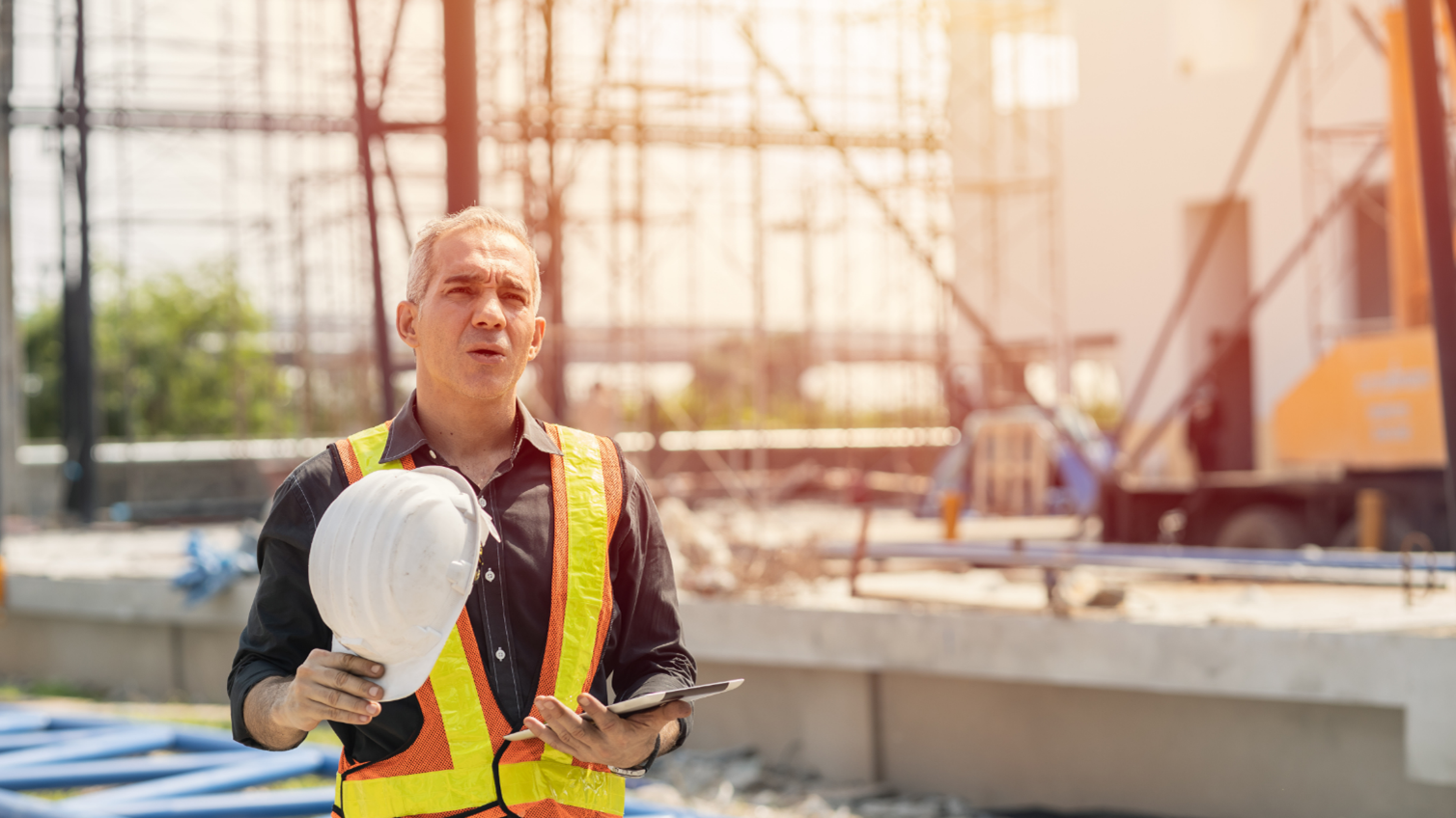 A construction worker taking a water break on a construction site.