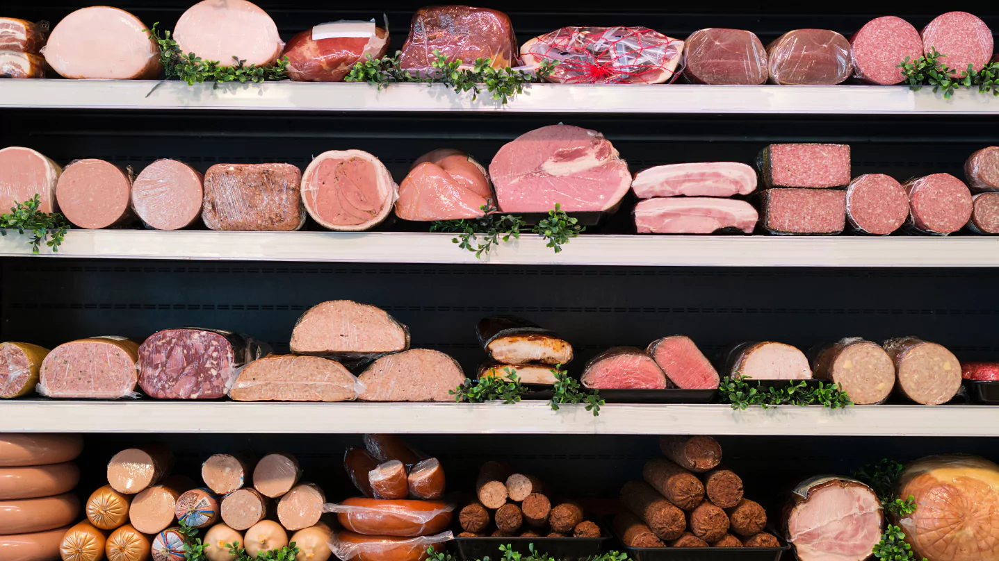 A variety of meats are on display in a store.