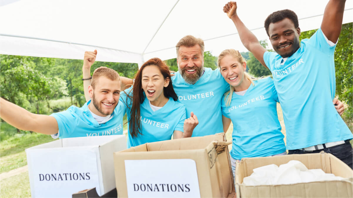 A Group of Volunteer People With Donation Box in Front