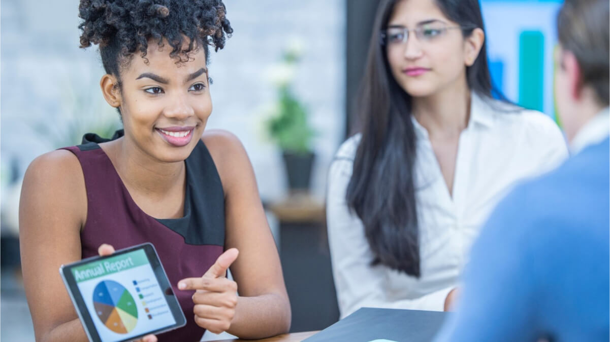 A Person Holding a Tablet With A Person in the Background