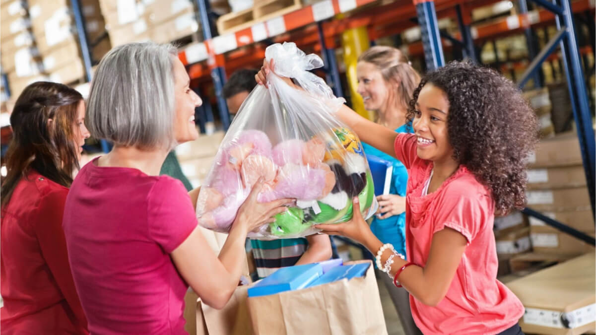 A Person and a Child Holding a Bag of Toys