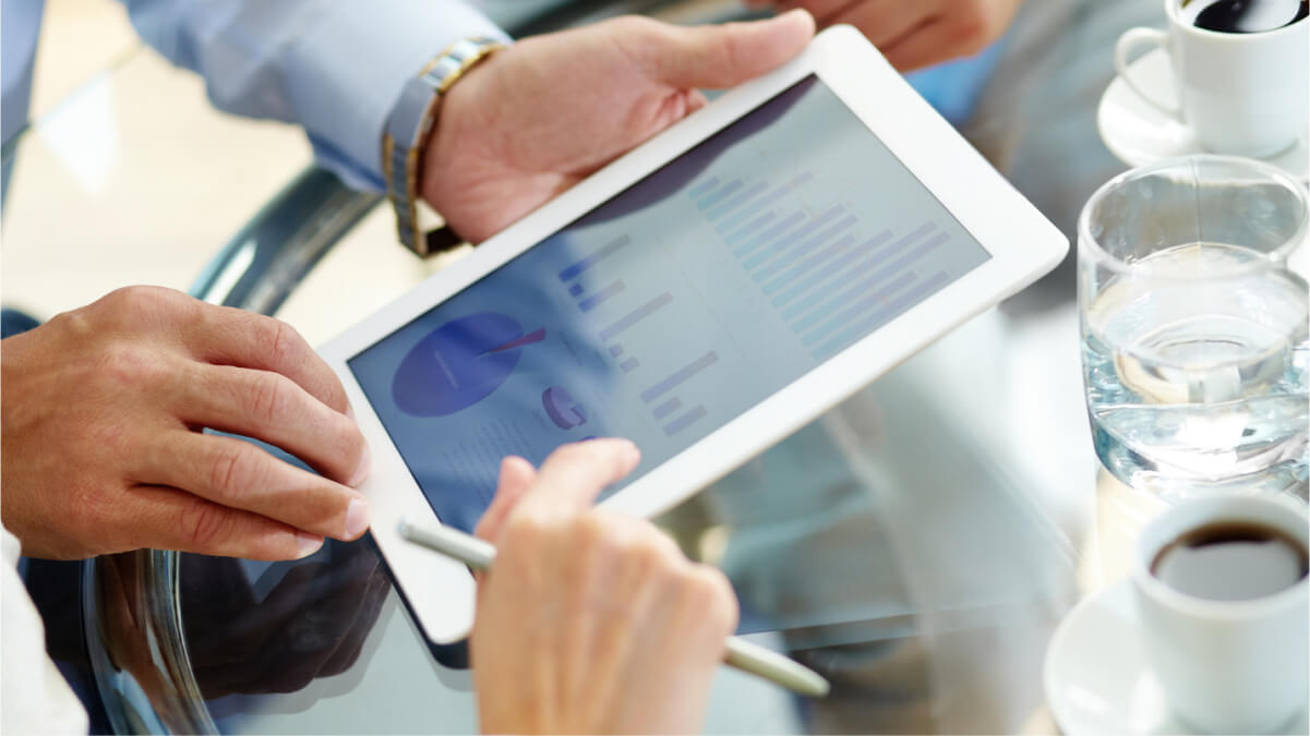 A close-up of hands holding a tablet