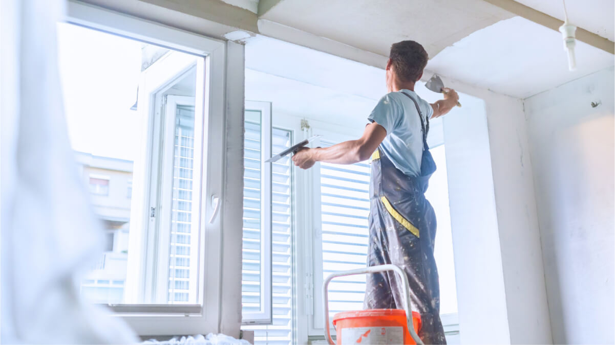 A person painting a wall