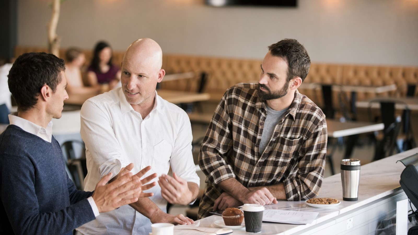 A group of men sitting at a table