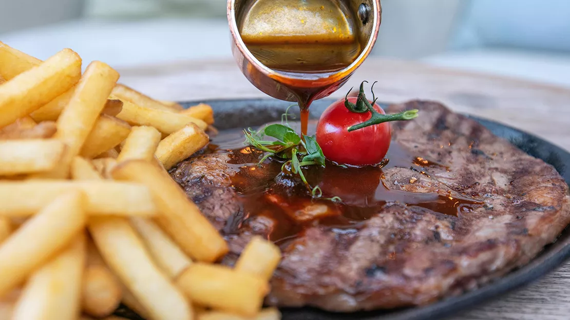 Closeup image of fries and steak