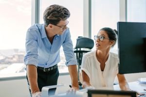 A man and a woman talking about MBE CPAs open positions