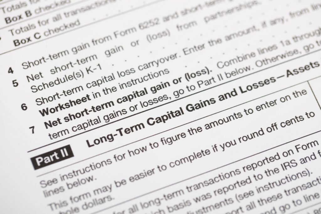 Close-up detail of official IRS tax form sections covering short-term and long-term capital gains and losses.