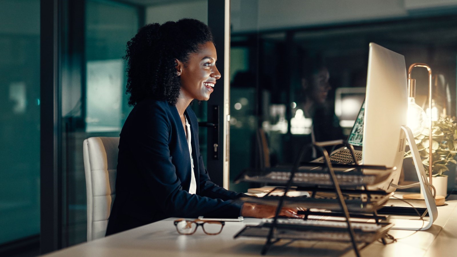 A person sitting at a table looking at a computer