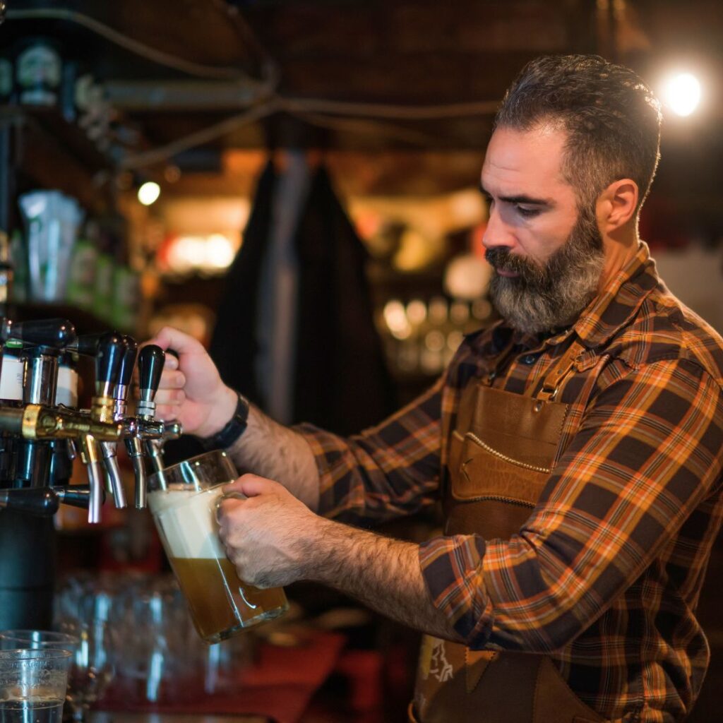 a man pouring a beer