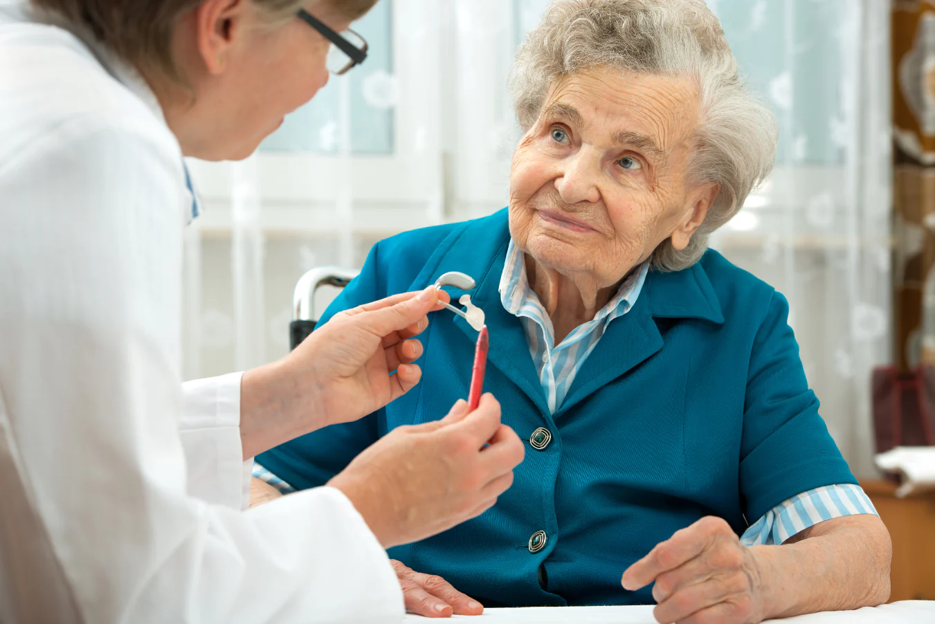 Audiologist assist elderly patient