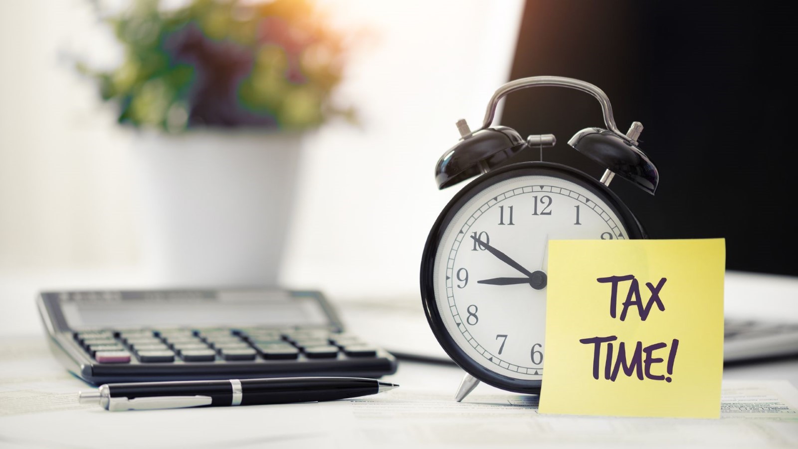 A alarm clock next to a keyboard