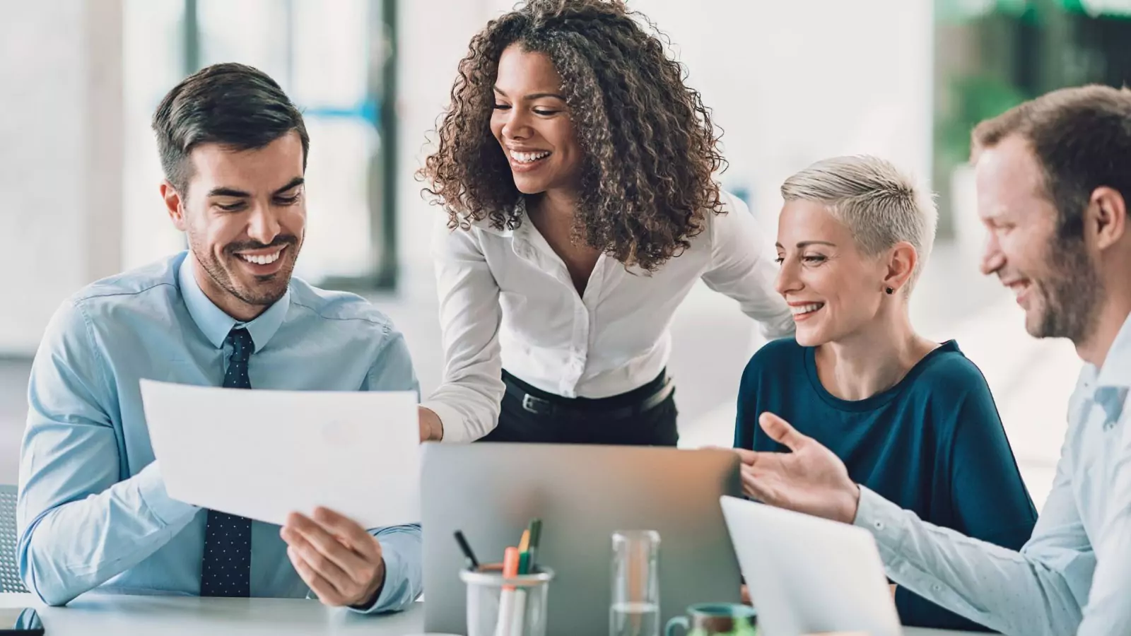 A group of people looking at a paper