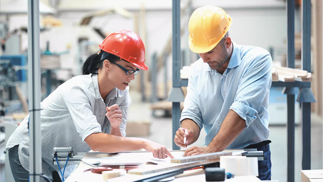 A person and person wearing hard hats