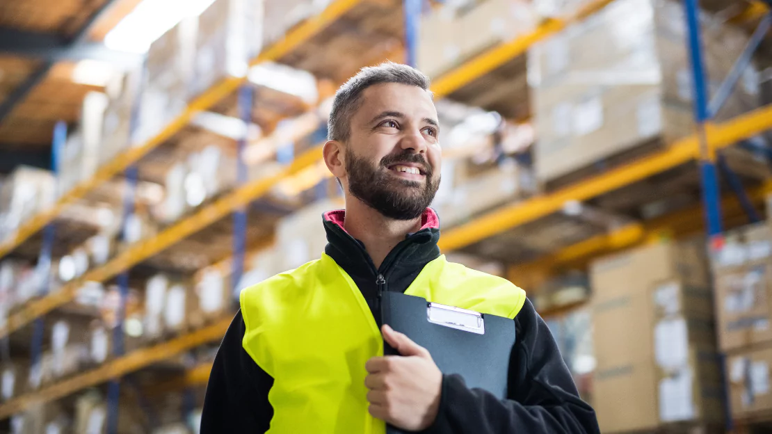 A person in a yellow vest holding a clipboard