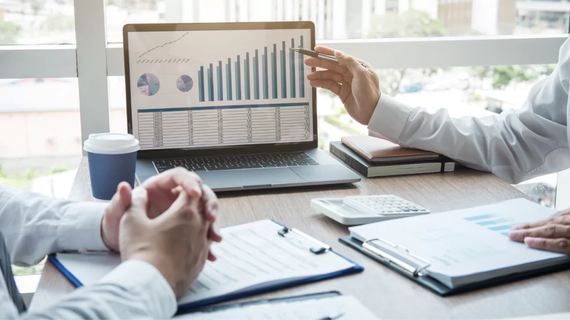 Hand pointing the line graph report - Business Deal