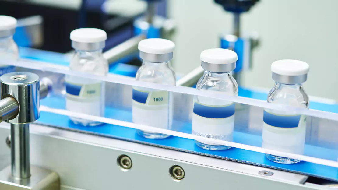 Several vials on a conveyor belt