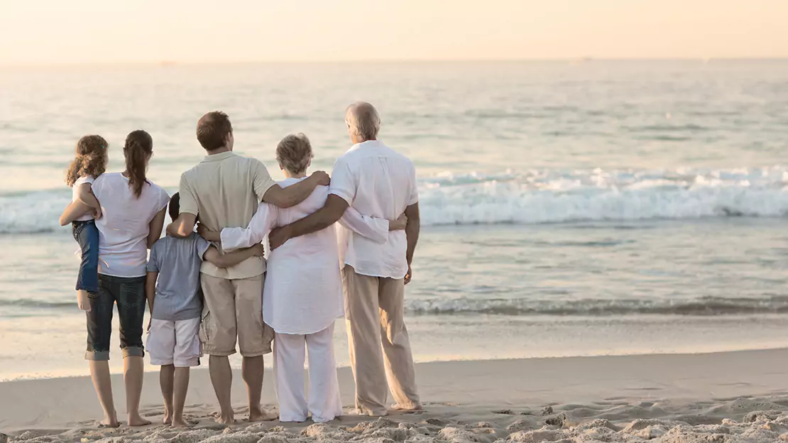 Family Holding each other while at the Beach