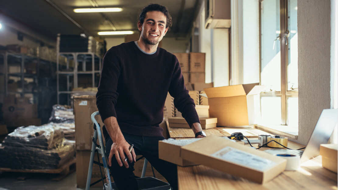A person sitting on a chair in a room with boxes