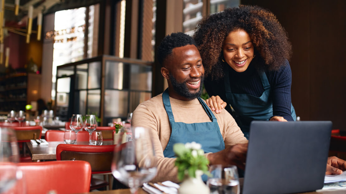 Business Owners Looking at a Laptop