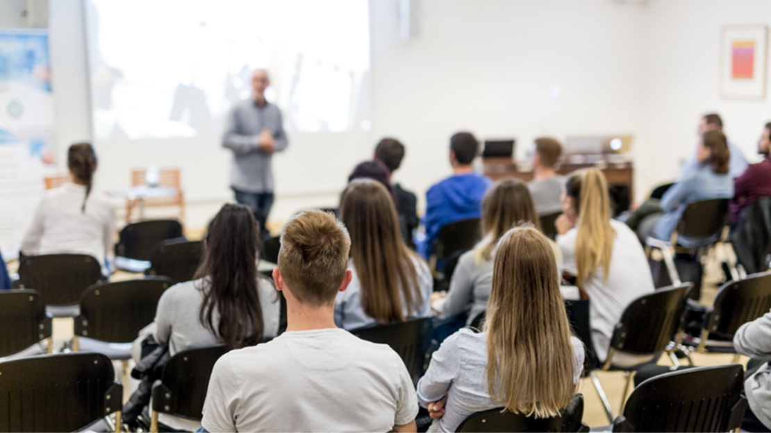 A person standing in front of a group of people