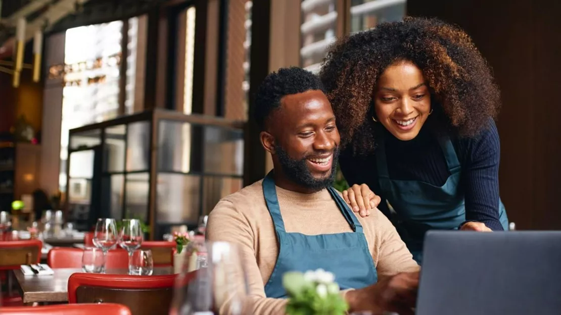 A person and person looking at a computer