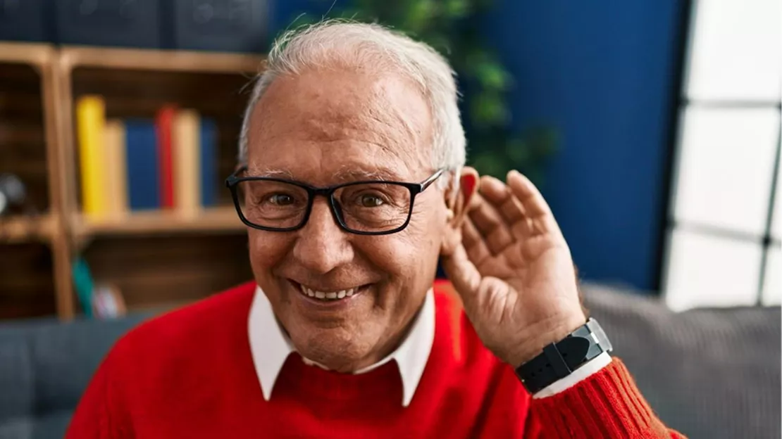 A person wearing glasses and a red sweater