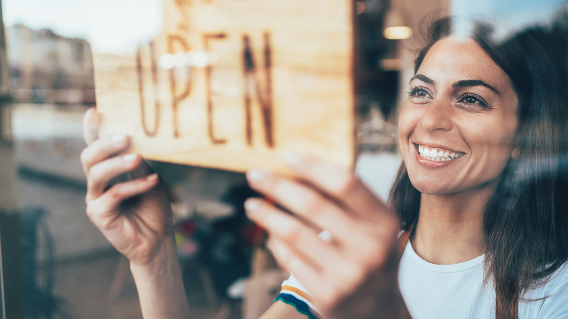 Woman Flipping the Open and Close Signage