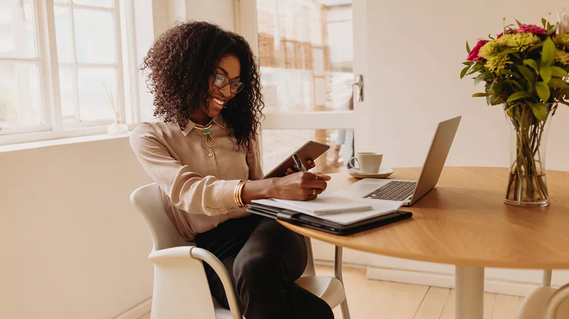 Women smiling while taking notes