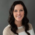 Professional headshot of Chelsey Lamker, at MBE CPAs, smiling against a dark background.
