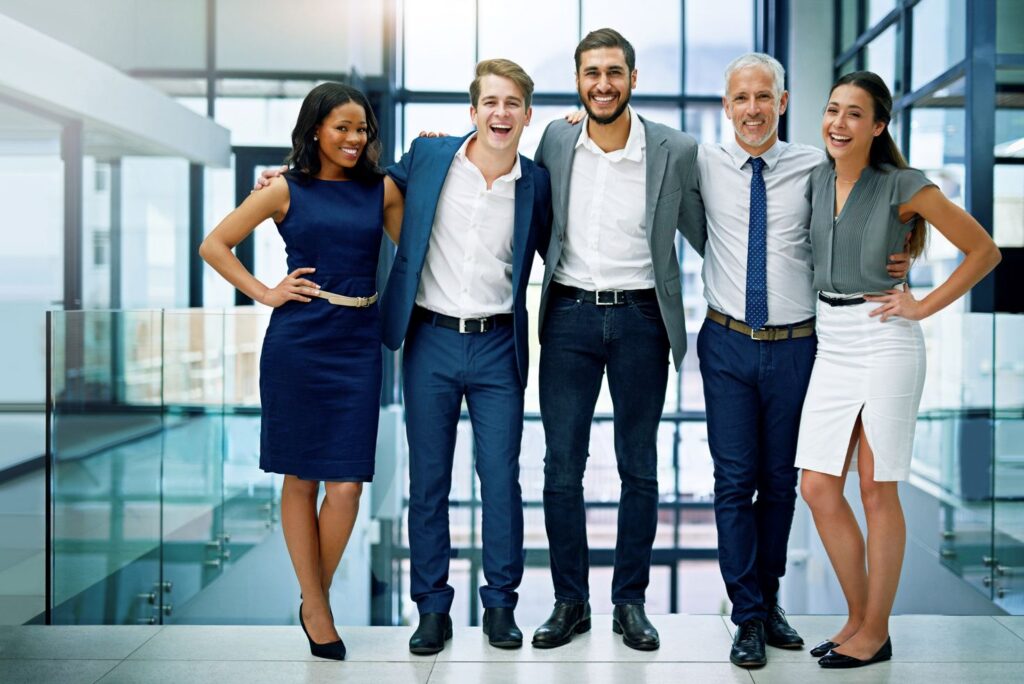 A group of business professionals smiling towards the camera