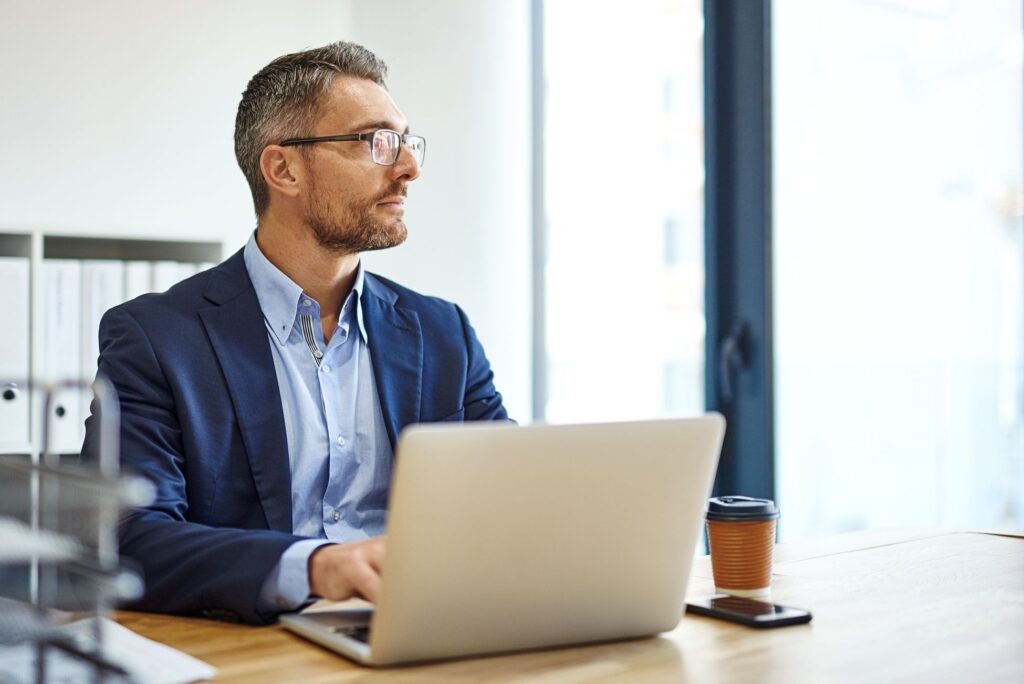 Man in an office working on a laptop