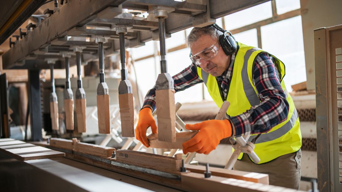 Man Using CNC Machine in Production