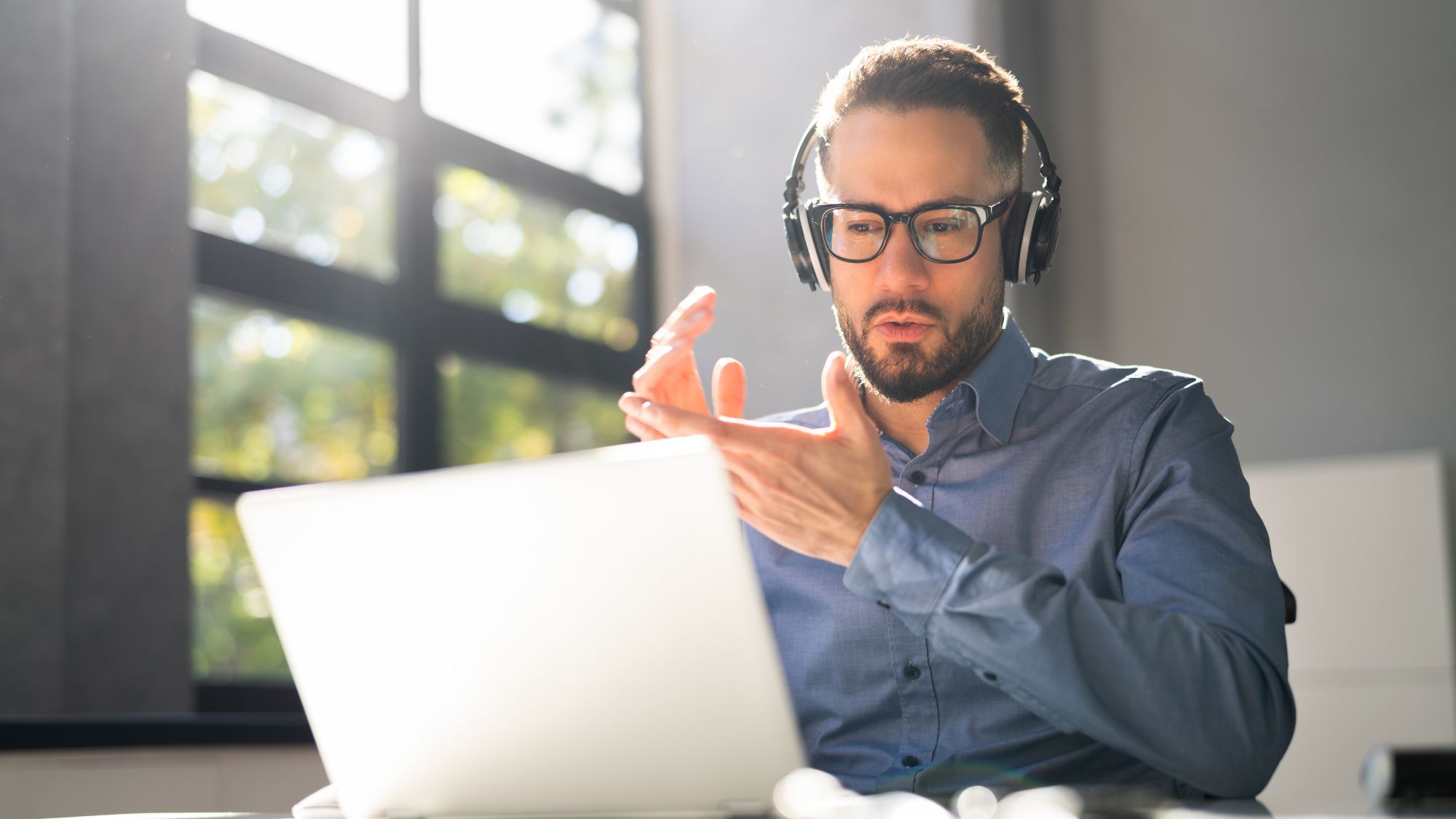 A Man in a Virtual Meeting Wearing a Headset