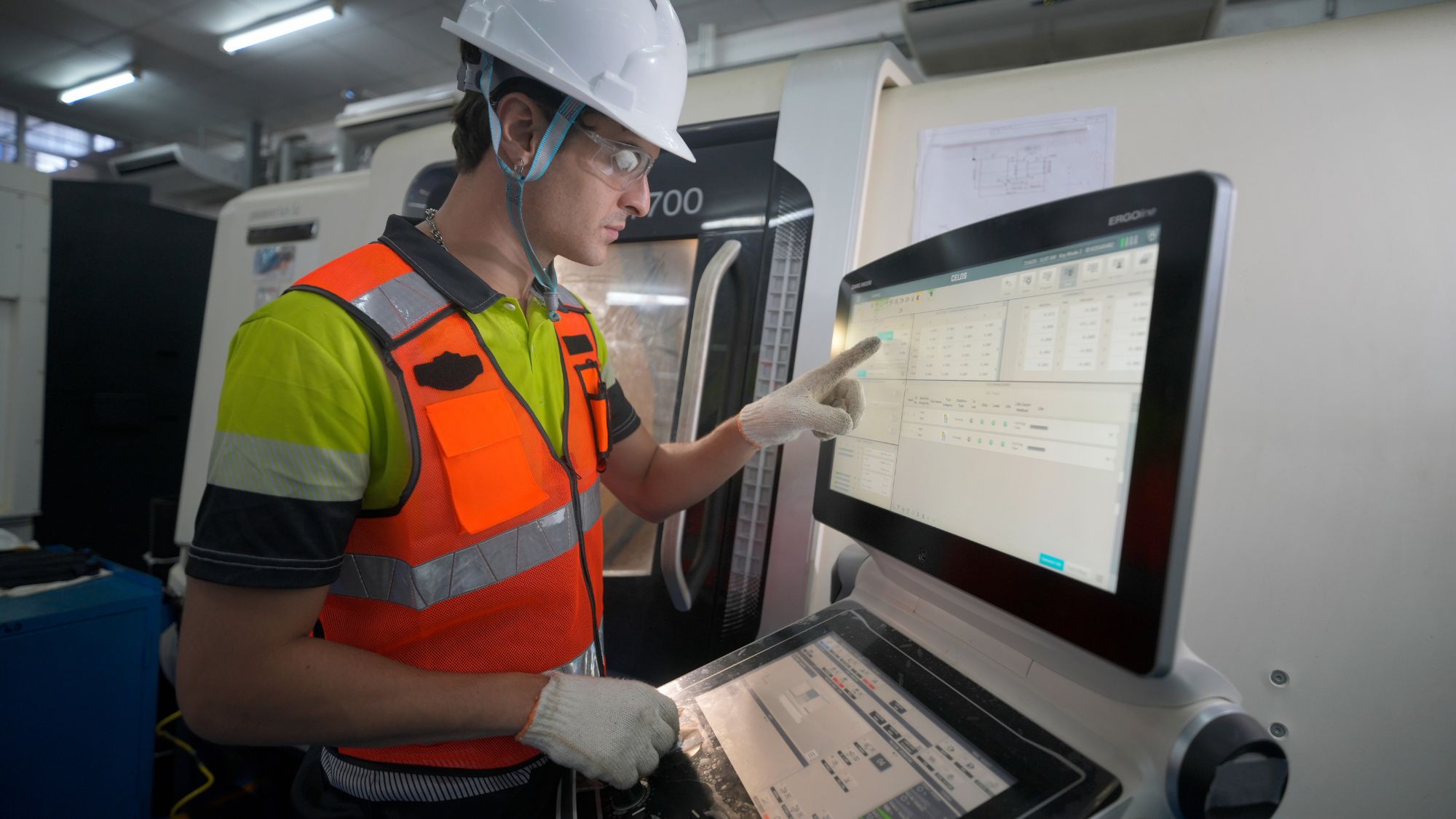 A worker is analyzing data displayed on the screen