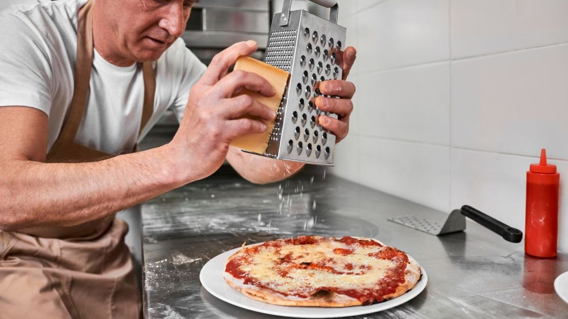 Adding Cheese toppings on Pizza