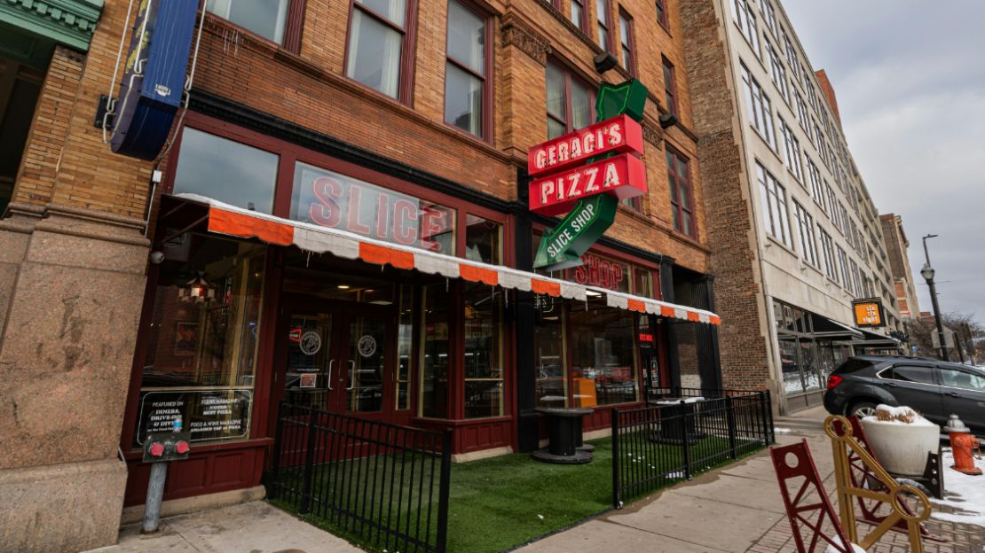 Exterior of the restaurant featuring pizza signage