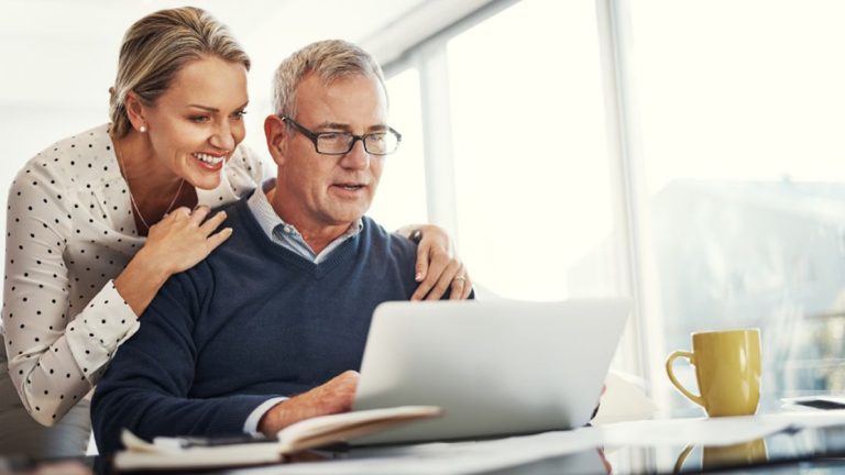 Man and Woman Smiling at the Laptop