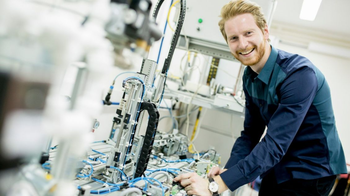 Manufacturing staff smiling in a production area