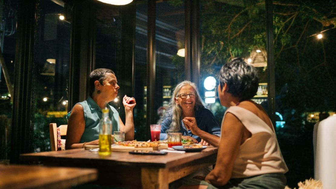 Three women are enjoying their food