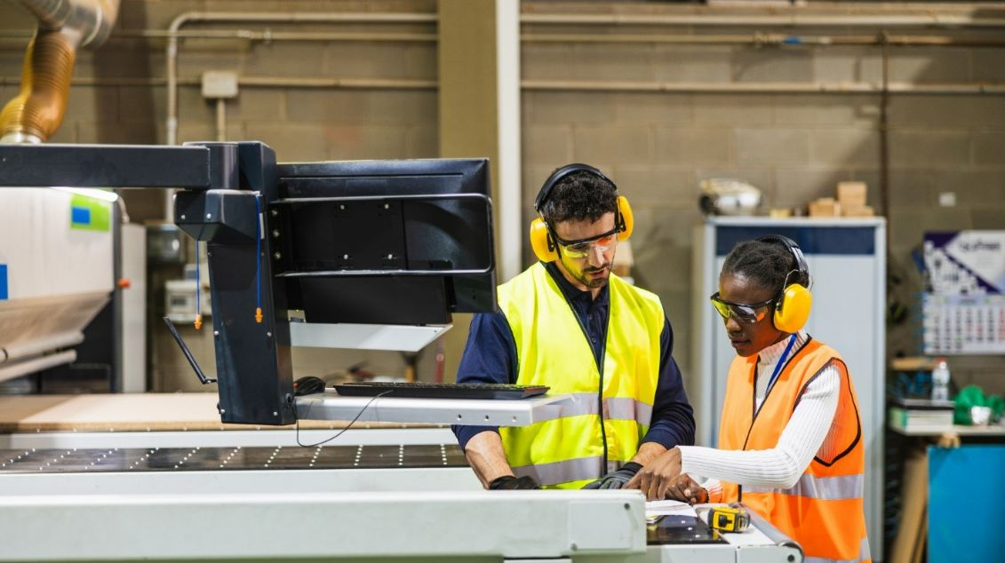 Two manufacturing workers in a production area