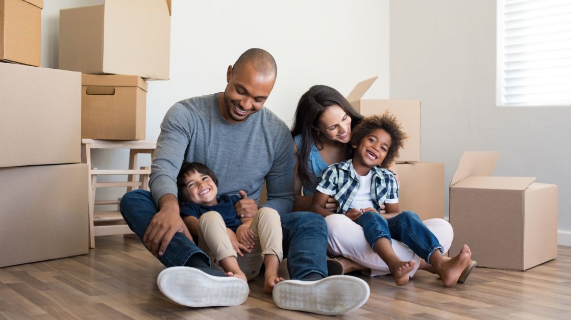 Family Enjoying Together While Sitting on the Floor