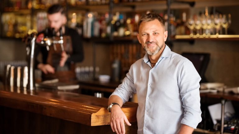 Restaurant owners smiling while looking at the laptop