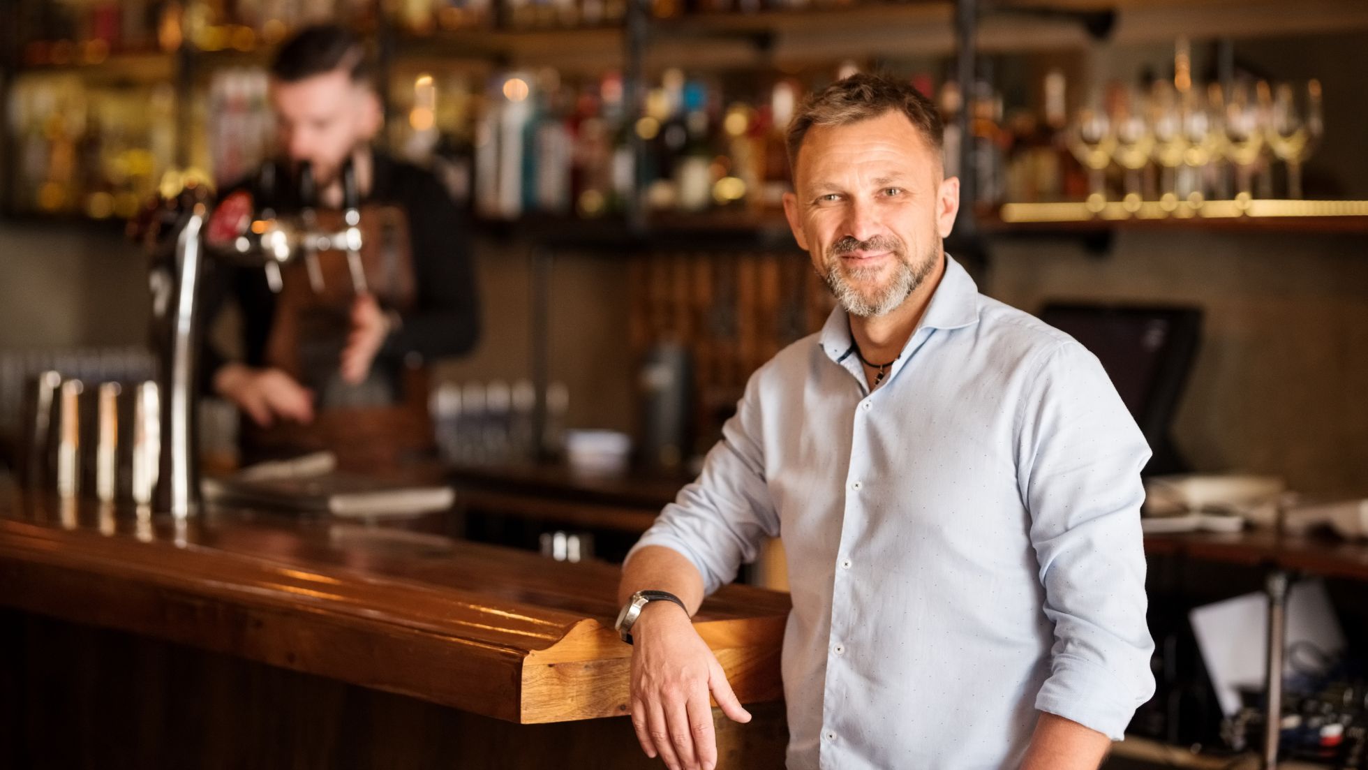 Restaurant owners smiling while looking at the laptop