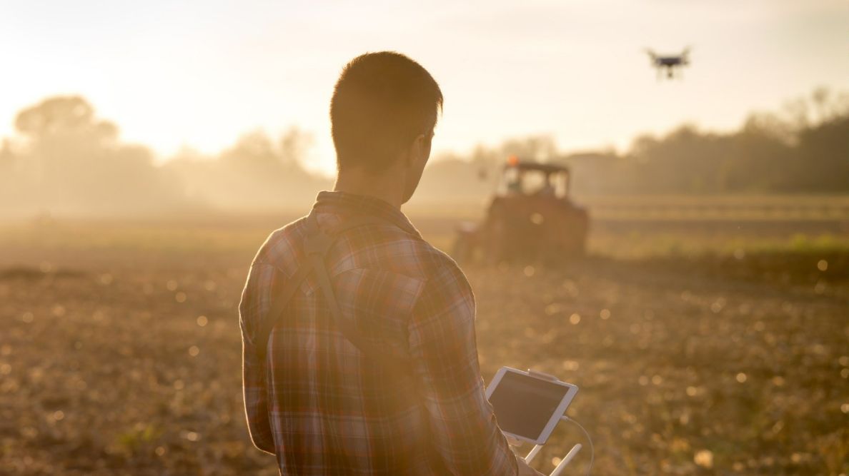 Agribusiness owner flying a drone over farmland