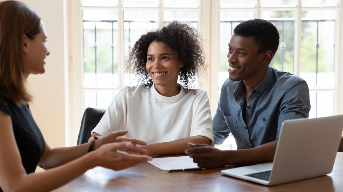 Smiling Couple Listening to Their Advisor