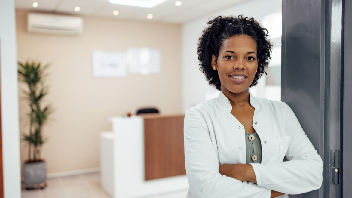 Woman smiling in the lobby of an audiology clinic